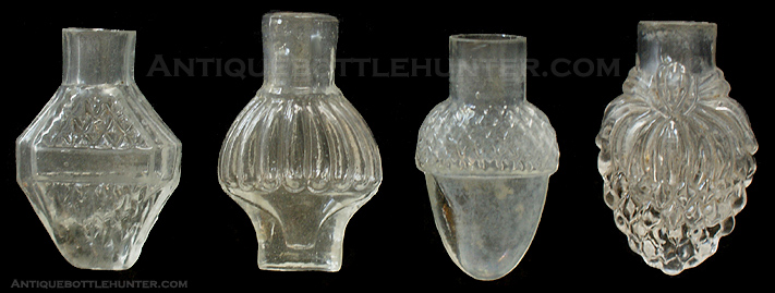Four colorless smelling bottles in various shapes. --- AntiqueBottleHunter.com