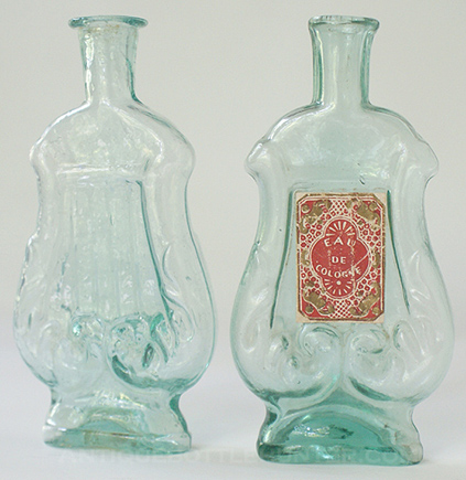 Two aquamarine 'Lyre' colognes with four strings on one side. (Both 4 - 3/4 in.) --- AntiqueBottleHunter.com