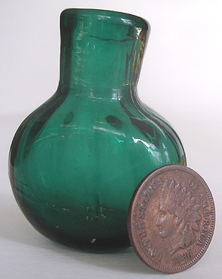 A blue/green (at times emerald) pattern-molded diminutive smelling bottle or scent, with 14 vertical ribs and pontil mark. Height, 1 - 3/4 in. Width, 1 - 3/8 in. Pictured next to an old penny. --- AntiqueBottleHunter.com