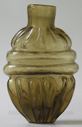 An olive green smelling bottle or scent with twelve ribs above two horizonal larger ribs above ten lower ribs. Height, 2 - 3/4 in. Width, 1 - 3/4 in. --- AntiqueBottleHunter.com