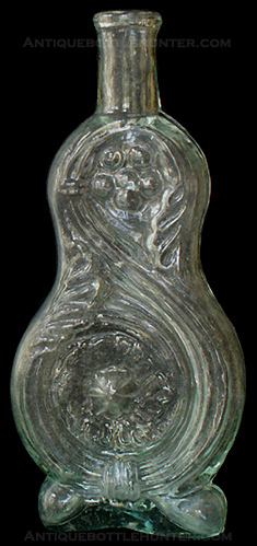 An aquamarine cologne with scrolled leaves and flowers in a pear or figure eight shape. Similar to McK. plate 108, no. 8 (5 - 7/8 in.). --- AntiqueBottleHunter.com
