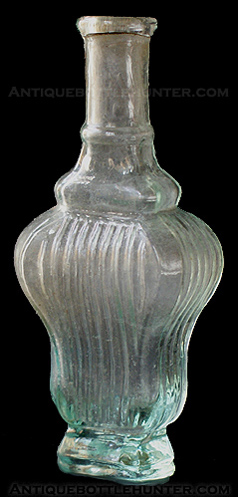 A ribbed (3 sides) cologne with a letter of embossing on the very top of each side of the neck: H W & Co. --- AntiqueBottleHunter.com
