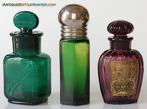 A dark emerald green GARWOOD, a tall medium yellow green hexagon shaped label only salts with ground stopper and screw top closure, and then a dark amethyst beauty (ground stopper) with a gold foil label with flowers that reads: Smelling Salts, Richard Hudnut, New York - Paris. Heights w/out stoppers, 3 in., 4 - 3/16 in. (including top), 2 - 3/4 in. --- AntiqueBottleHunter.com