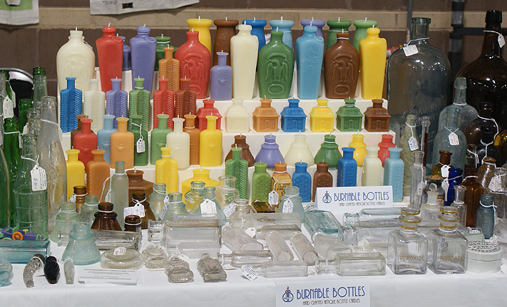 A picture of our show table (10.6.12) featuring bottle candles available from Burnable Bottles --- Burnable Bottles - AntiqueBottleHunter.com