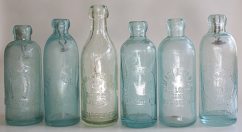 A GROUP OF HUTCHES - SODA BOTTLES