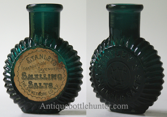 A blue/green (teal) salts bottle embossed STANLEY'S LAVENDER SALTS with WCo. monogram centered. Label reads: Stanley's Inexhaustible Lavender Smelling Salts, The S.H. Wetmore Co. N.Y. Height, 2 - 5/16 in. Width, 1 - 3/4 in. --- AntiqueBottleHunter.com