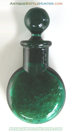 A teal green, yet unembossed variant, the same size and form of a LUSCOMB'S LAVENDER SALTS (above) and still filled with salts. --- AntiqueBottleHunter.com