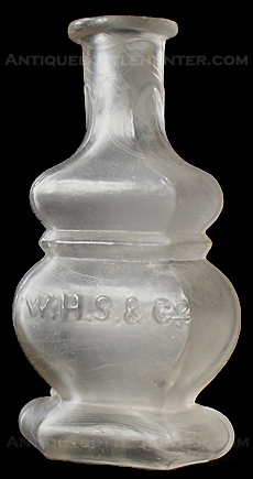 A colorless - wavy flint-like glass polygonal type cologne embossed in the center W.H.S. & Co. --- AntiqueBottleHunter.com