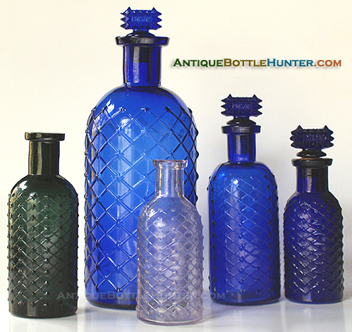 A group photo of lattice and diamond cylinder poisons, including a teal green, a light amethyst (SCA) and some blues --- Antiquebottlehunter.com